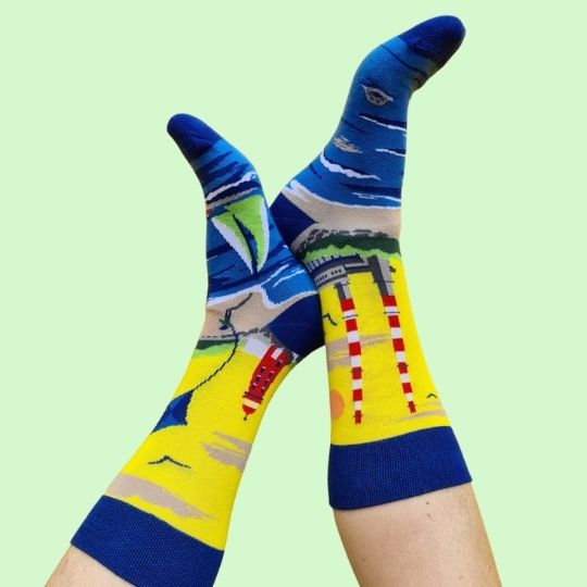 Enjoy the unique panoramic "sockscape" design, that includes Poolbeg Towers, Poolbeg Lighthouse, the Great south Wall, Dublin Bay with a sailing boat and a Cheeky Seal.